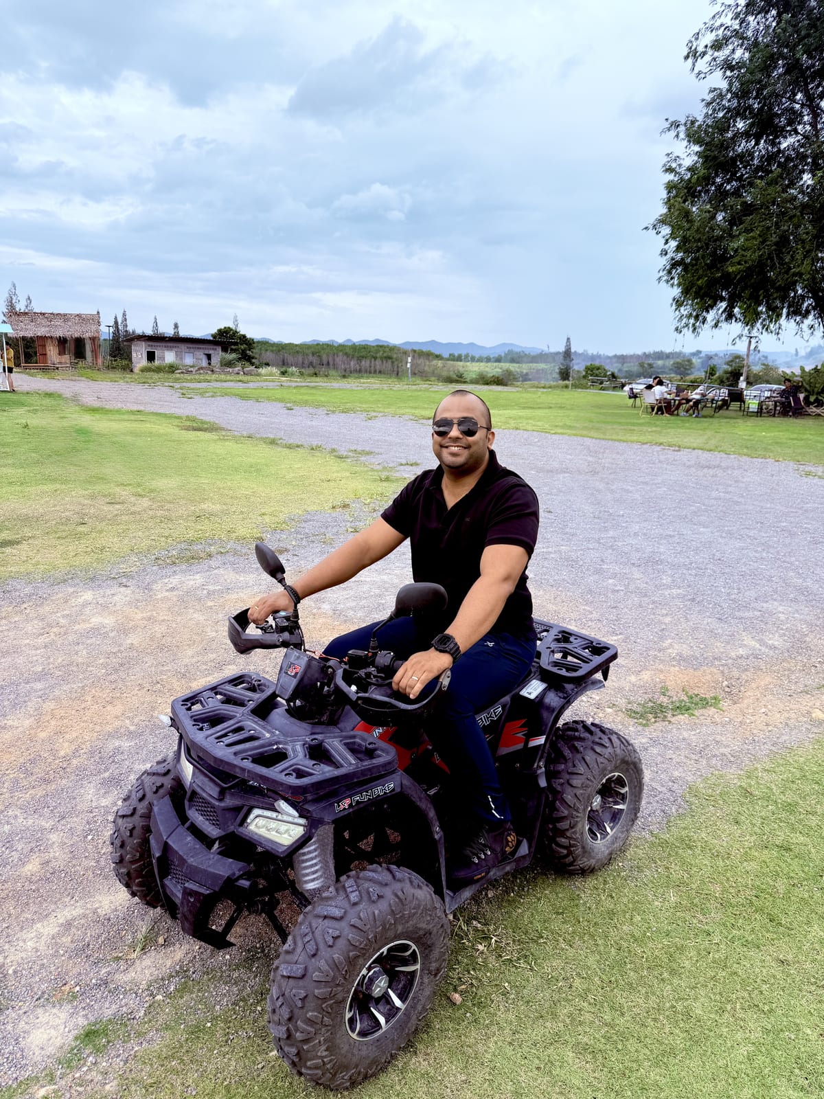 Saurabh riding an ATV in the countryside